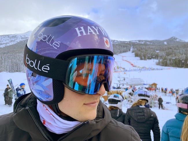 Brodie Seger, of Canada, wears his ALS competition helmet at the FIS World Cup downhill ski race in Lake Louise, Alta., Friday, Nov. 26, 2021. Seger's new purple and blue, beflowered helmet is the product of his fundraising campaign for the ALS Society of B.C. Seger's father, Mark, has lived with the condition for nine years. THE CANADIAN PRESS/Frank Gunn