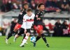 Stuttgart's Mateo Klimowicz, left, and Mainz's Jean-Paul Boetius battle for the ball during the Bundesliga soccer match at Mercedes-Benz Arena in Stuttgart, Germany, Friday Nov. 26, 2021. (Tom Weller/dpa via AP)