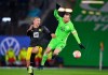 Dortmund's Erling Haaland, left, and Wolfsburg's Maximilian Arnold challenge for the ball during the German Bundesliga soccer match between VfL Wolfsburg and Borussia Dortmund in Wolfsburg, Germany, Saturday, Nov. 27, 2021. (Swen Pfoertner/dpa via AP)
