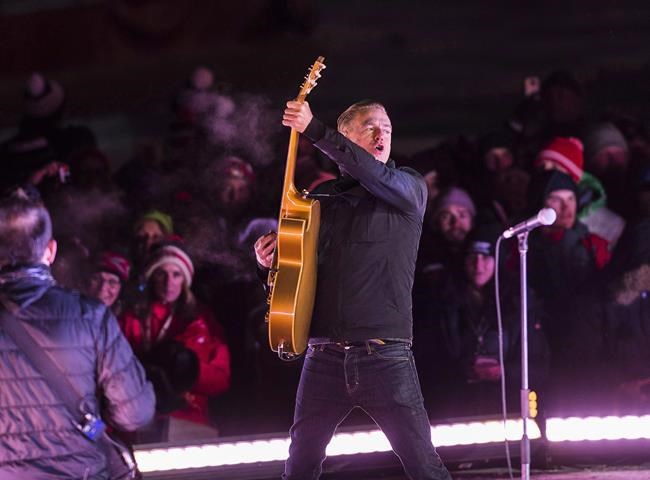 Bryan Adams plays during second intermission at the NHL 100 Classic, in Ottawa, Saturday, Dec. 16, 2017. Canadian musician Bryan Adams says he has once again tested positive for a COVID-19, less than a month after pulling out of a Rock & Roll Hall of Fame performance because of a positive test. THE CANADIAN PRESS/Sean Kilpatrick