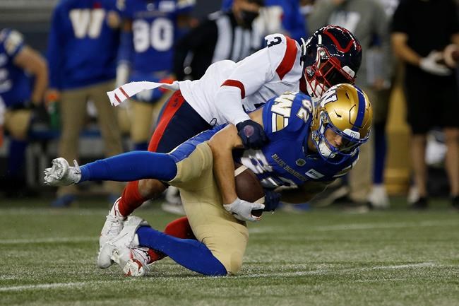 Winnipeg Blue Bombers' Drew Wolitarsky (82) gets tacked by Montreal Alouettes' Patrick Levels (3) after a reception during the first half of CFL action in Winnipeg Saturday, November 6, 2021. On Monday, the Montreal Alouettes linebacker guaranteed his team would beat the Hamilton Tiger-Cats in the East Division final, he wasn't backing down from the claim Saturday. THE CANADIAN PRESS/John Woods