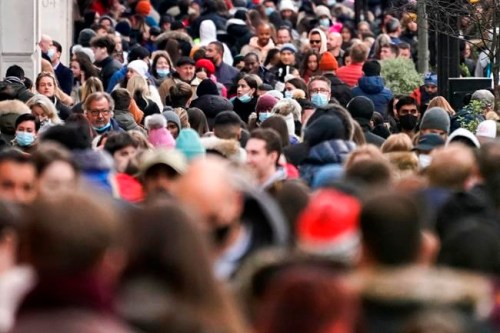 People, some wearing face masks, walk in Regent Street, in London, Sunday, Nov. 28, 2021. Britain's Prime Minister Boris Johnson said it was necessary to take 