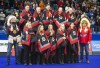 Whitecap Dakota First Nation Chief Darcy Bear, left, and Saskatoon Tribal Council Tribal Chief Mark Arcand, right, pose with Team Gushue, winners of the men's final and Team Jones, winners of the women's final, at the podium after receiving star blankets during the 2021 Canadian Olympic curling trials in Saskatoon, Sunday, November 28, 2021. THE CANADIAN PRESS/Rick Elvin