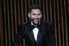 PSG player Lionel Messi reacts after winning the 2021 Ballon d'Or trophy during the 65th Ballon d'Or ceremony at Theatre du Chatelet, in Paris, Monday, Nov. 29, 2021. (AP Photo/Christophe Ena)