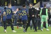 Manchester United's caretaker manager Michael Carrick, 3rd left, shakes hands with Manchester United's Jadon Sancho and Scott McTominay at the end of a Group F Champions League soccer match between Villarreal and Manchester United at the Ceramica stadium in Villarreal, Spain, Tuesday, Nov. 23, 2021. (AP Photo/Alberto Saiz)