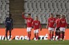 Benfica's Julian Weigl, 2nd left, celebrates after scoring his side's third goal during the Portuguese Primeira Liga soccer match between Belenenses SAD and SL Benfica, Saturday, Nov. 27, 2021. Belenenses SAD started the match with only nine players due to a coronavirus outbreak. Portuguese health authorities on Monday, Nov. 29, 2021, identified 13 cases of omicron, the new coronavirus variant spreading fast globally, among members of Belenenses SAD. (AP Photo/Pedro Rocha)