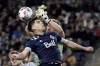 Sporting Kansas City goalkeeper Tim Melia, back, blocks a pass by Vancouver Whitecaps forward Brian White, front, during the second half of an MLS soccer match in Kansas City, Kan., on November 20, 2021. THE CANADIAN PRESS/AP, Charlie Riedel