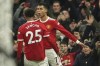 Manchester United's Cristiano Ronaldo, right, celebrates with Manchester United's Jadon Sancho after scoring his side's third goal during the English Premier League soccer match between Manchester United and Arsenal at Old Trafford stadium in Manchester, England, Thursday, Dec. 2, 2021. (AP Photo/Dave Thompson)