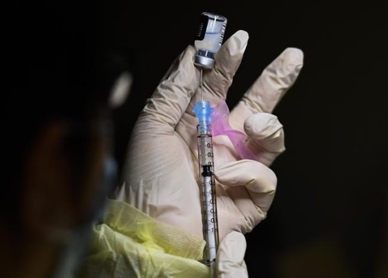 A registered pharmacist technician carefully fills the Pfizer-BioNTech COVID-19 mRNA vaccine at a vaccine clinic during the COVID-19 pandemic in Toronto on Tuesday, December 15, 2020. The National Advisory Committee on Immunizations is set to release new guidance this morning on the use of COVID-19 vaccine boosters as public health faces down the threat of the new Omicron COVID-19 variant. THE CANADIAN PRESS/Nathan Denette