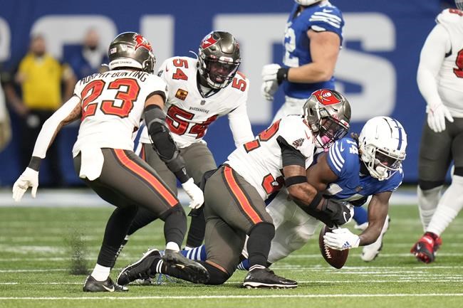 Indianapolis Colts' Zach Pascal (14) fumbles as he is hit by Tampa Bay Buccaneers' Mike Edwards (32) during the first half of an NFL football game, Sunday, Nov. 28, 2021, in Indianapolis. (AP Photo/AJ Mast)