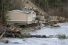 A home has its foundation ripped away by the Coquihalla River near Hope, B.C., Thursday, Dec. 2, 2021. THE CANADIAN PRESS/Jonathan Hayward