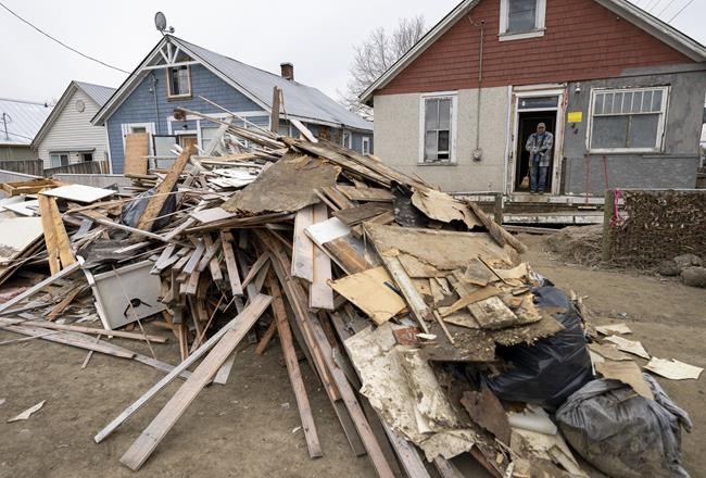 The contents to the insides of homes that were flooded are pictured on the street in downtown Princeton, B.C., Friday, Dec. 3, 2021. Princeton, like many parts of the province, was hit with heavy floods and mudslides over the past couple of weeks causing major devastation. THE CANADIAN PRESS/Jonathan Hayward