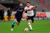 Stuttgart's Roberto Massimo, right, and Hertha's Marvin Plattenhardt fight for the ball during the German Bundesliga soccer match between Stuttgart and Herta BSC in Stuttgart, Germany, Sunday, Dec. 5, 2021. (Tom Weller/dpa via AP)