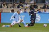 Philadelphia Union's Olivier Mbaizo, right, reacts as he goes for the ball against New York City FC's Alexander Callens, left, during the first half of an MLS playoff soccer match, Sunday, Dec. 5, 2021, in Chester, Pa. (AP Photo/Chris Szagola)