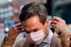 Danish golfer Thorbjorn Olesen puts on a face mask as he arrives at Aldersgate House Crown Court, in London, Monday, Dec. 6, 2021. The five-time European Tour winner was arrested on his return from the World Golf Championships-FedEx St Jude Invitational on a flight from Nashville to London on July 29, 2019, accused of sexual assault, being drunk on an aircraft and assault by beating. (AP Photo/Alberto Pezzali)