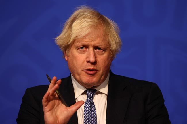 Britain's Prime Minister Boris Johnson speaks at a press conference in London's Downing Street, Wednesday Dec. 8, 2021, after ministers met to consider imposing new restrictions in response to rising cases and the spread of the omicron variant. (Adrian Dennis/Pool via AP)