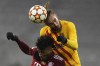 Bayern's Kingsley Coman, foreground, and Barcelona's Oscar Mingueza jump for the ball during the Champions League group E soccer match between Bayern Munich and FC Barcelona in Munich, Germany, Wednesday, Dec. 8, 2021. (AP Photo/Matthias Schrader)
