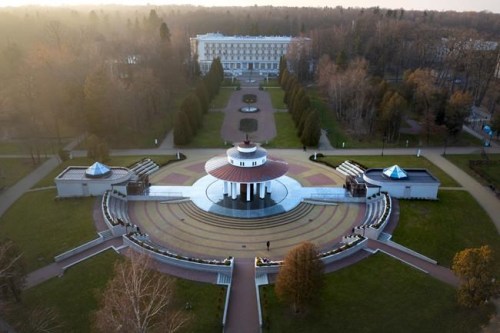 An aerial view, with the spa sanatorium in the background, of Morshyn, Ukraine, Wednesday, Nov. 17, 2021. In Morshyn, a scenic town nestled at the Carparthian foothills in the Lviv region, 74% of 3,439 residents have been fully vaccinated. A small spa town in western Ukraine stands out in a country where just under a quarter of the population has received coronavirus vaccines. (AP Photo/Efrem Lukatsky)