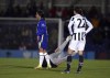 A pitch invader is grounded courtesy of Chelsea's Sam Kerr during the Women's Champions League, Group A match between Chelsea and Juventus at Kingsmeadow, London, Wednesday, Dec. 8, 2021. Kerr took matters into her own hands when a man holding a cell phone entered the field and held up play during a big Women’s Champions League match. The Chelsea striker walked near to the man as he was finally being ushered back off the field and then barged him to the ground to cheers from fans. (John Walton/PA via AP)
