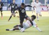 CF Montreal's Romell Quioto (30) breaks away from Toronto FC's Julian Dunn during first half Canadian Championship soccer action in Montreal, Sunday, November 21, 2021. Defender Julian Dunn is leaving Toronto FC for Norway's HamKam.&nbsp; THE CANADIAN PRESS/Graham Hughes