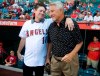 FILE - Jim Fregosi, Jr., left, shares a moment with Angels great Bobby Knoop before throwing out the first pitch in honor of his late father Jim Fregosi before a baseball game against the Philadelphia Phillies at Angel Stadium in Anaheim, Calif. Fregosi Jr., a special assistant in the Kansas City Royals' front office and a son of the longtime major league manager, died Thursday, Dec. 9, 2021, in Los Angeles, the Royals said. He was 57. (Kevin Sullivan/The Orange County Register via AP)