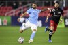 FILE - New York City FC midfielder Valentin Castellanos (11) shoots in front of D.C. United midfielder Junior Moreno (5) during an MLS soccer match, on, April 17, 2021, in Washington. The Portland Timbers are leery of Castellanos, and for good reason. The striker was named Major League Soccer's Golden Boot winner with 19 goals this season. (AP Photo/Will Newton, File)