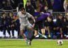 Georgetown's Zach Riviere (27) grabs Washington's Scott Gustafson (13) as they chase the ball during the first half of an NCAA men's soccer tournament semifinal in Cary, N.C., Friday, Dec. 10, 2021. (AP Photo/Ben McKeown)