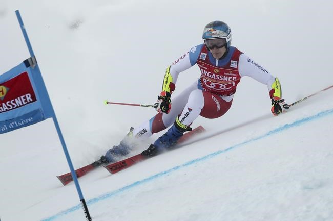 Switzerland's Marco Odermatt speeds down the course during the first run of an alpine ski, men's World Cup giant slalom, in Val D'Isere, France, Saturday, Dec. 11, 2021. (AP Photo/Gabriele Facciotti)