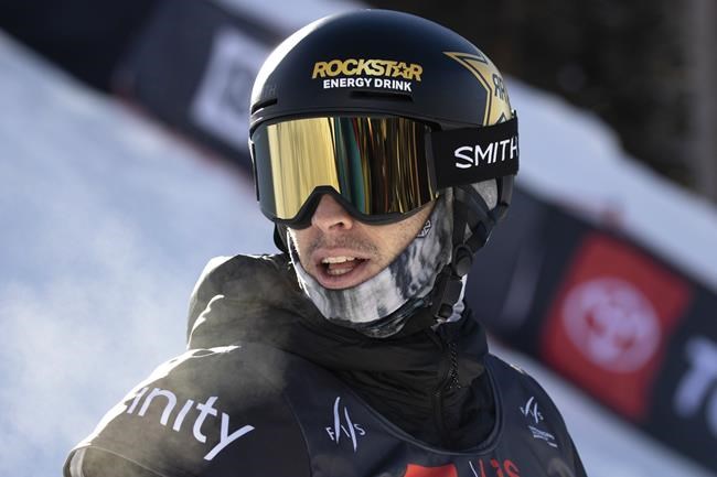 Chase Josey, of United States, checks the score following his run in the halfpipe finals Saturday, Dec. 11, 2021, at the U.S. Grand Prix snowboarding event at Copper Mountain, Colo. (AP Photo/Hugh Carey)