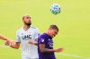Orlando City midfielder Junior Urso (11) heads the ball in front of New England Revolution forward Teal Bunbury (10) during the first half of an MLS playoff soccer match, Sunday, Nov. 29, 2020, in Orlando, Fla. THE CANADIAN PRESS/AP, Matt Stamey
