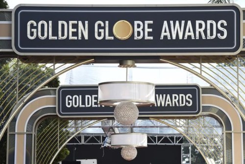 FILE - Event signage appears above the red carpet at the 77th annual Golden Globe Awards, Sunday, Jan. 5, 2020, in Beverly Hills, Calif. The Hollywood Foreign Press Association will announce nominations to the 79th Golden Globes, early Monday, Dec. 13, 2021. (Photo by Jordan Strauss/Invision/AP, File)