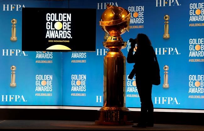 A photographer shoots a Golden Globe statue at the nominations event for 79th annual Golden Globe Awards at the Beverly Hilton Hotel on Monday, Dec. 13, 2021, in Beverly Hills, Calif. The 79th annual Golden Globe Awards will be held on Sunday, Jan. 9, 2022. (AP Photo/Chris Pizzello)