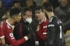 Manchester United's Cristiano Ronaldo, left and goalkeeper David de Gea, right, talk to Victor Lindelof, 3rd from left as he holds his chest before having to leave the field during the English Premier League soccer match between Norwich City and Manchester United at Carrow road in Norwich, England, Saturday, Dec.11, 2021. (AP Photo/Rui Vieira)