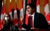 Prime Minister Justin Trudeau answers a question as Minister of Families, Children and Social Development Karina Gould listens during a press conference in Ottawa, on Monday, Dec. 13, 2021. Prime Minister Justin Trudeau has consulted the premiers on additional border and travel measures that could help slow the community spreading of COVID-19.THE CANADIAN PRESS/Justin Tang
