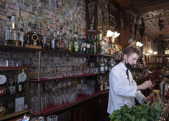 Bartender Antoine prepares a Bloody Mary cocktail at the Harry's Bar in Paris, Friday, Dec. 10, 2021. Harry's Bar in Paris is celebrating the 100th birthday of the Bloody Mary, the vodka-tomato juice cocktail believed to have been invented in the iconic bar in 1921. The centenary events this week come as a welcome respite from winter gloom and spreading worries about the omicron virus variant. (AP Photo/Rafael Yaghobzadeh)