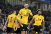 Wolverhampton Wanderers' Romain Saiss, center, celebrates scoring with teammates during the English Premier League soccer match between Brighton & Hove Albion and Wolverhampton Wanderers at AMEX Stadium, Brighton, England, Wednesday Dec. 15, 2021. (Gareth Fuller/PA via AP)