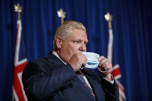 Ontario Premier Doug Ford puts his mask back on after speaking during a news conference at Queen's Park in Toronto, Wednesday, Dec. 15, 2021. Public health responses to protect against the Omicron variant vary across Canada, even as COVID-19 cases continue to rise in the country's two most populous provinces. THE CANADIAN PRESS/Cole Burston