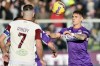 Fiorentina's Lucas Martinez Quarta, right, goes for the ball during the Serie A soccer match between Fiorentina and Salernitana, at the Artemio Franchi stadium in Florence, Italy, Saturday, Dec. 11, 2021. (Massimo Paolone /LaPresse via AP)