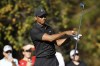 Tiger Woods spins his club after teeing off on the fourth hole during the first round of the PNC Championship golf tournament Friday, Dec. 17, 2021, in Orlando, Fla. Woods is back playing after getting injured in a car accident. He is paired with his son Charlie during the tournament. (AP Photo/Scott Audette)