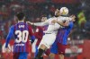Sevilla's Rafa Mir, left, vies for the ball with Barcelona's Ronald Araujo during the Spanish La Liga soccer match between Sevilla and Barcelona at the Ramon Sanchez-Pizjuan stadium, in Seville, Spain, Tuesday, Dec. 21, 2021. (AP Photo/Angel Fernandez)