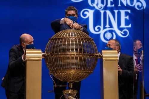 Workers prepare prize lottery balls at Madrid's Teatro Real opera house during Spain's bumper Christmas lottery draw known as El Gordo, or The Fat One, in Madrid, Spain, Wednesday, Dec. 22, 2021. The draw, held annually since 1812, will dish out a total of 2.4 billion euros ($2.7 billion) in prizes this year. People can queue for hours in the days running up to the lottery to snatch their 20-euro tickets from the most popular vendors. (AP Photo/Bernat Armangue)