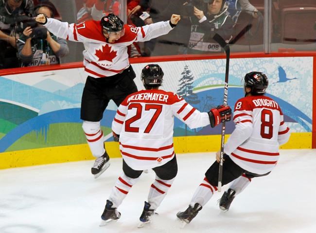 Canada's Sidney Crosby celebrates his game-winning goal with Scott Niedermayer and Drew Doughty during overtime period men's ice hockey gold medal final at the 2010 Winter Olympic Games in Vancouver on February 28, 2010.The NHL has officially announced that its players won't be going to the 2022 Beijing Olympics.THE CANADIAN PRESS/Paul Chiasson