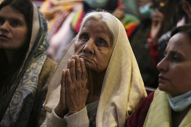 Christians attend a Christmas mass at Sacred Heart Cathedral, in Lahore, Pakistan, on Saturday, Dec. 25, 2021. (AP Photo/K.M. Chaudary)