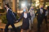 Elizabeth Holmes, second from left, walks out of federal court in San Jose, Calif., Friday, Dec. 17, 2021. (AP Photo/Nic Coury)