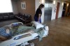 FILE - Medical staff transport a patient from a COVID-19 ward to the intensive care unit to be put on a ventilator, at the Willis Knighton Medical Center in Shreveport, La., Aug. 17, 2021. The explosive increase in U.S. coronavirus case counts is raising alarm, but some experts believe the focus should instead be on COVID-19 hospital admissions. And those aren't climbing as fast. (AP Photo/Gerald Herbert, File)