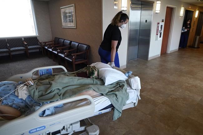 FILE - Medical staff transport a patient from a COVID-19 ward to the intensive care unit to be put on a ventilator, at the Willis Knighton Medical Center in Shreveport, La., Aug. 17, 2021. The explosive increase in U.S. coronavirus case counts is raising alarm, but some experts believe the focus should instead be on COVID-19 hospital admissions. And those aren't climbing as fast. (AP Photo/Gerald Herbert, File)