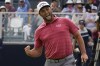 FILE - Jon Rahm, of Spain, reacts to making his birdie putt on the 18th green during the final round of the U.S. Open Golf Championship, June 20, 2021, at Torrey Pines Golf Course in San Diego. Rahm says he usually pumps his fist downward. This was upward toward his family across the green in a corporate box. (AP Photo/Gregory Bull, File)