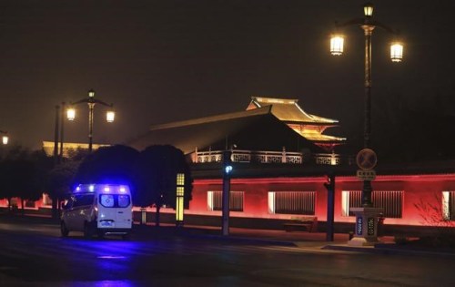 An ambulance drives along an empty street near a closed tourist site in Xi'an in northwestern China's Shaanxi Province, Thursday, Jan. 6, 2022. China's lockdown of big cities to fight coronavirus outbreaks is prompting concern about more disruptions to global industries after two makers of processor chips said their factories were affected. (Chinatopix via AP)