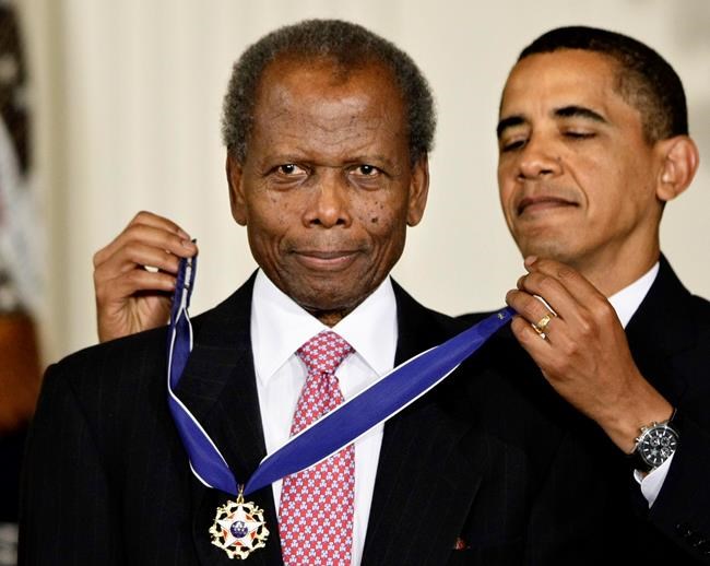 FILE - President Barack Obama presents the 2009 Presidential Medal of Freedom to Sidney Poitier during ceremonies in the East Room at the White House in Washington on, Aug. 12, 2009. Poitier, the groundbreaking actor and enduring inspiration who transformed how Black people were portrayed on screen, became the first Black actor to win an Academy Award for best lead performance and the first to be a top box-office draw, died Thursday, Jan. 6, 2022 in the Bahamas. He was 94. (AP Photo/J. Scott Applewhite, File)