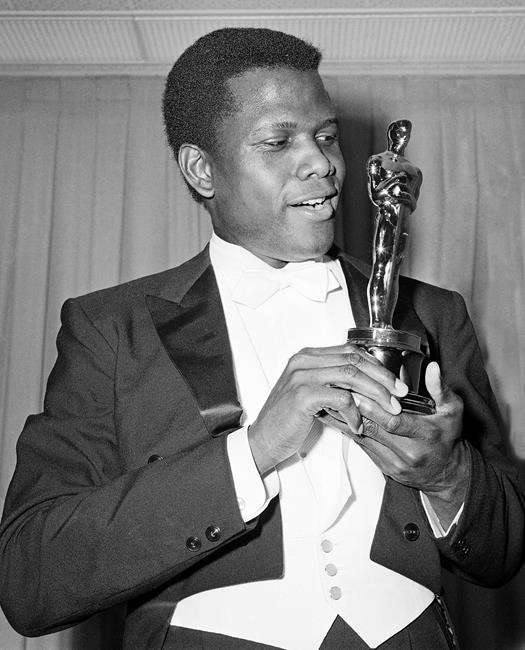 FILE - Actor Sidney Poitier poses with his Oscar for best actor for